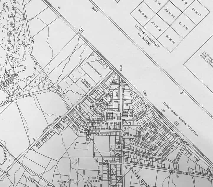Black and white map showing a detailed layout of streets, buildings, and plots in a suburban area, with labeled roads and grid references.